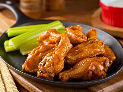 Buffalo chicken wings with celery sticks at Horseshoe Lounge & Restaurant in Collinsville, IL